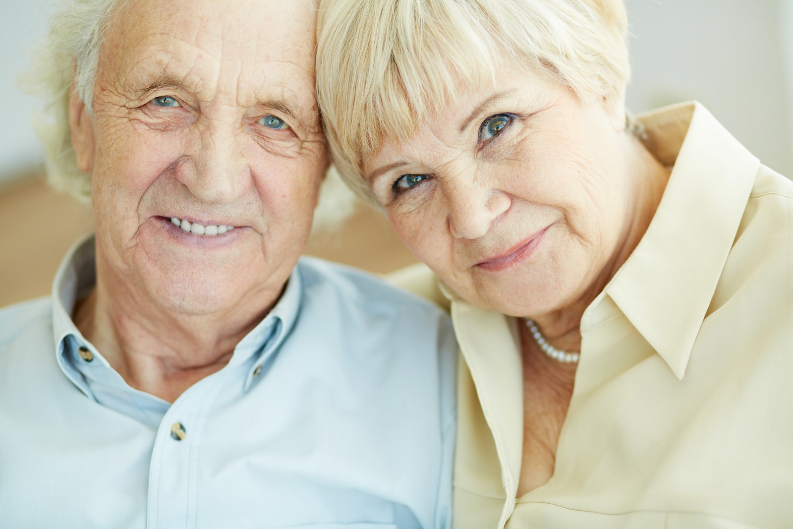 Portrait of senior couple looking at camera with smiles